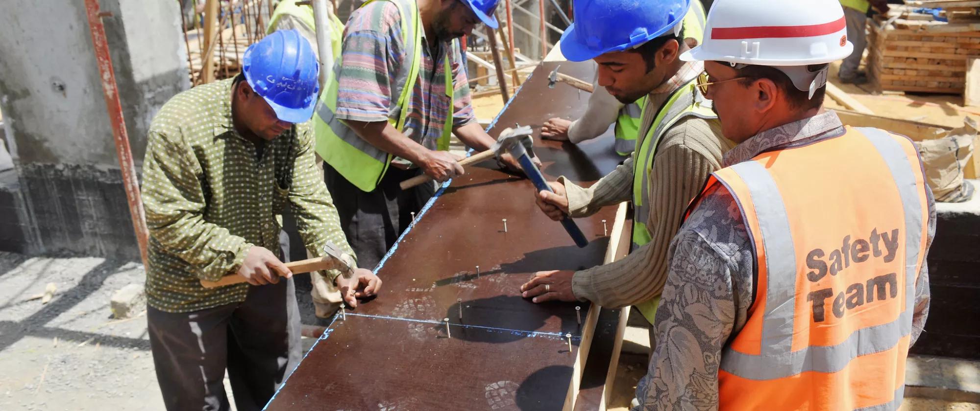 Workers on a construction site at the Airport Tower