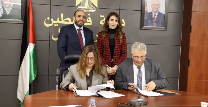 ILO OPT Officer in Charge, Ms. Rasha El Shurafa, and Al-Quds University President, Dr. Imad Abu Kishek, signing the strategic agreement.